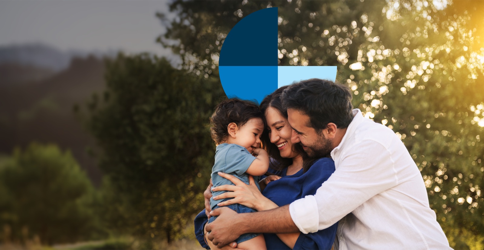 A family embracing outdoors at sunset