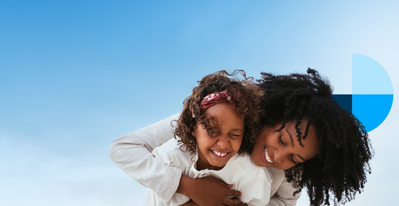 A parent and child laughing together