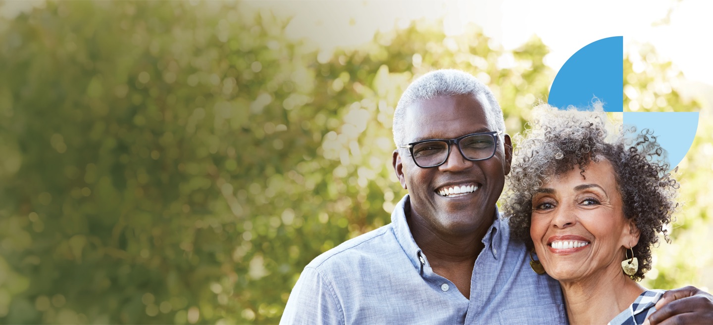 A smiling couple embracing outdoors
